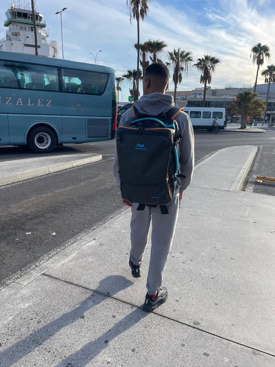 Man walking with TREKARIUS 35L carry-on travel backpack